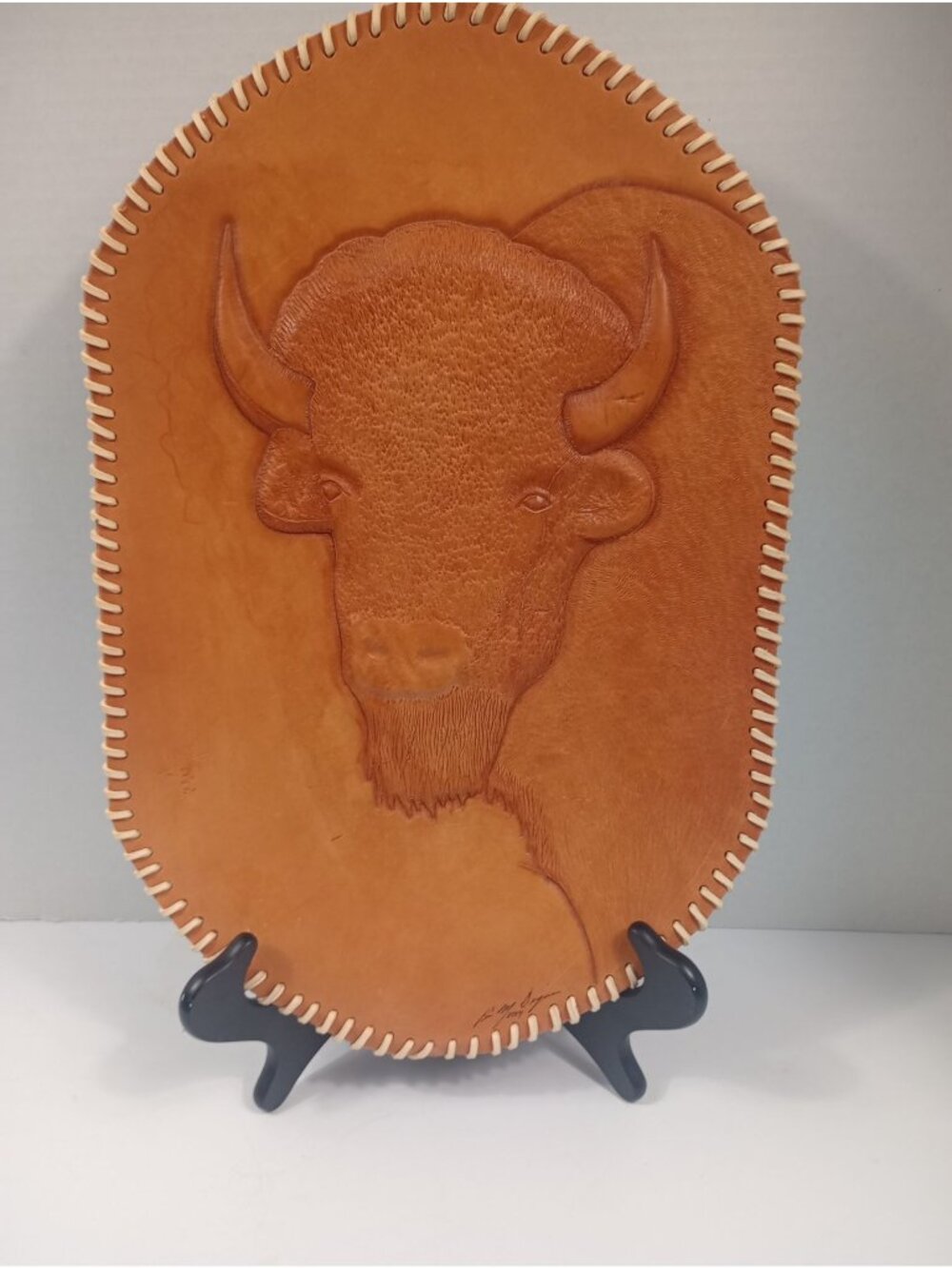 Hand Crafted Oval Tooled Leather Bison With an Open  Leather Stitch Trim Signed